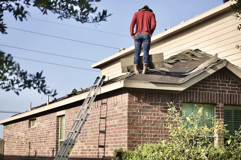 Professional roofer working on a residential roof in Little River